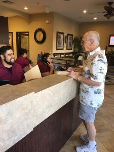 Image of a patient at the front desk