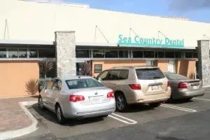 Sea Country Dental exterior — modern clinic with parked cars in front