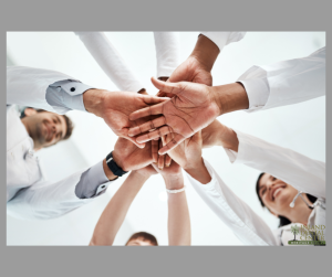 Medical professionals stacking hands in unity — teamwork concept